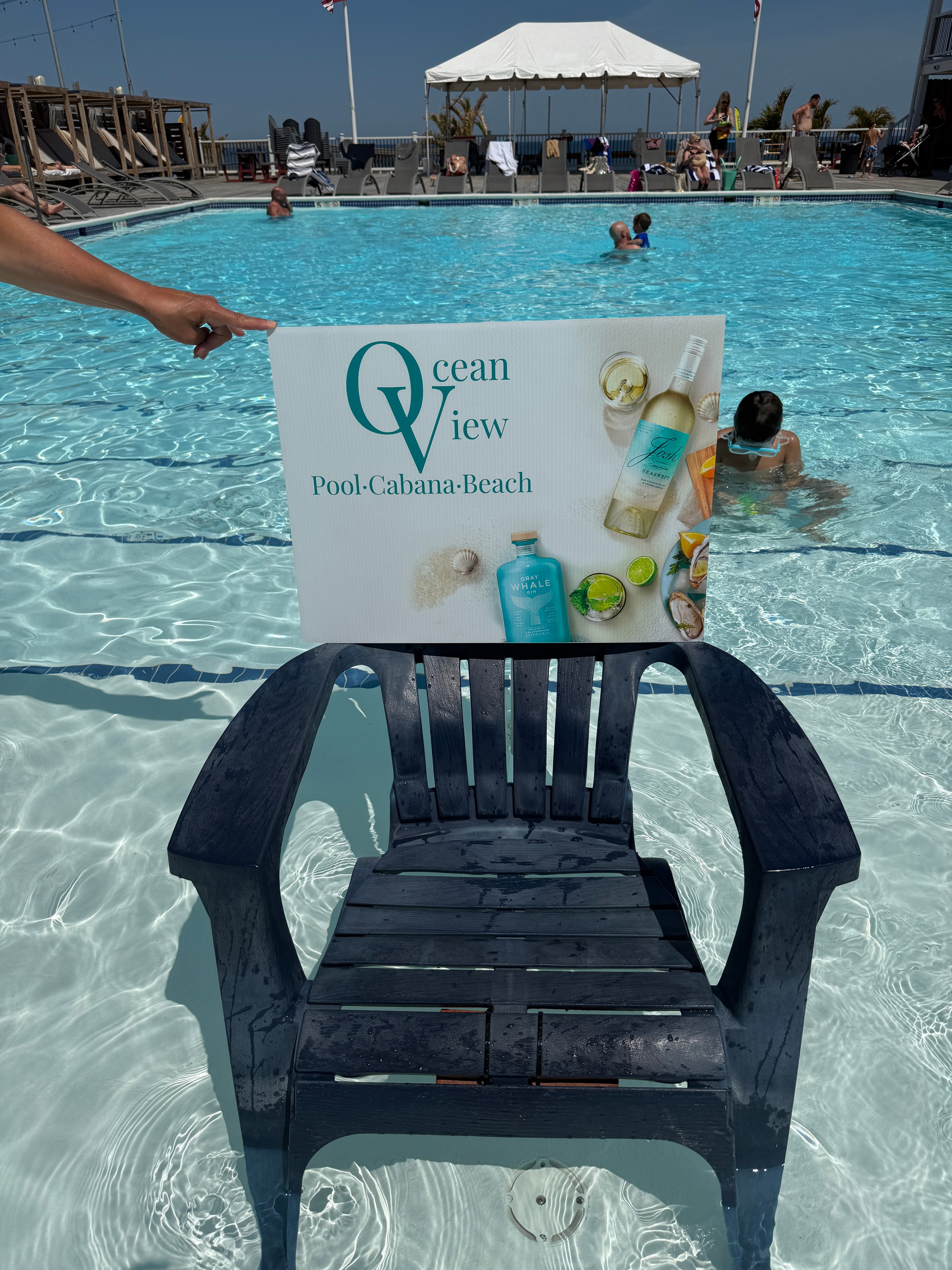 Ocean View branded sign poolside with Adirondack chair