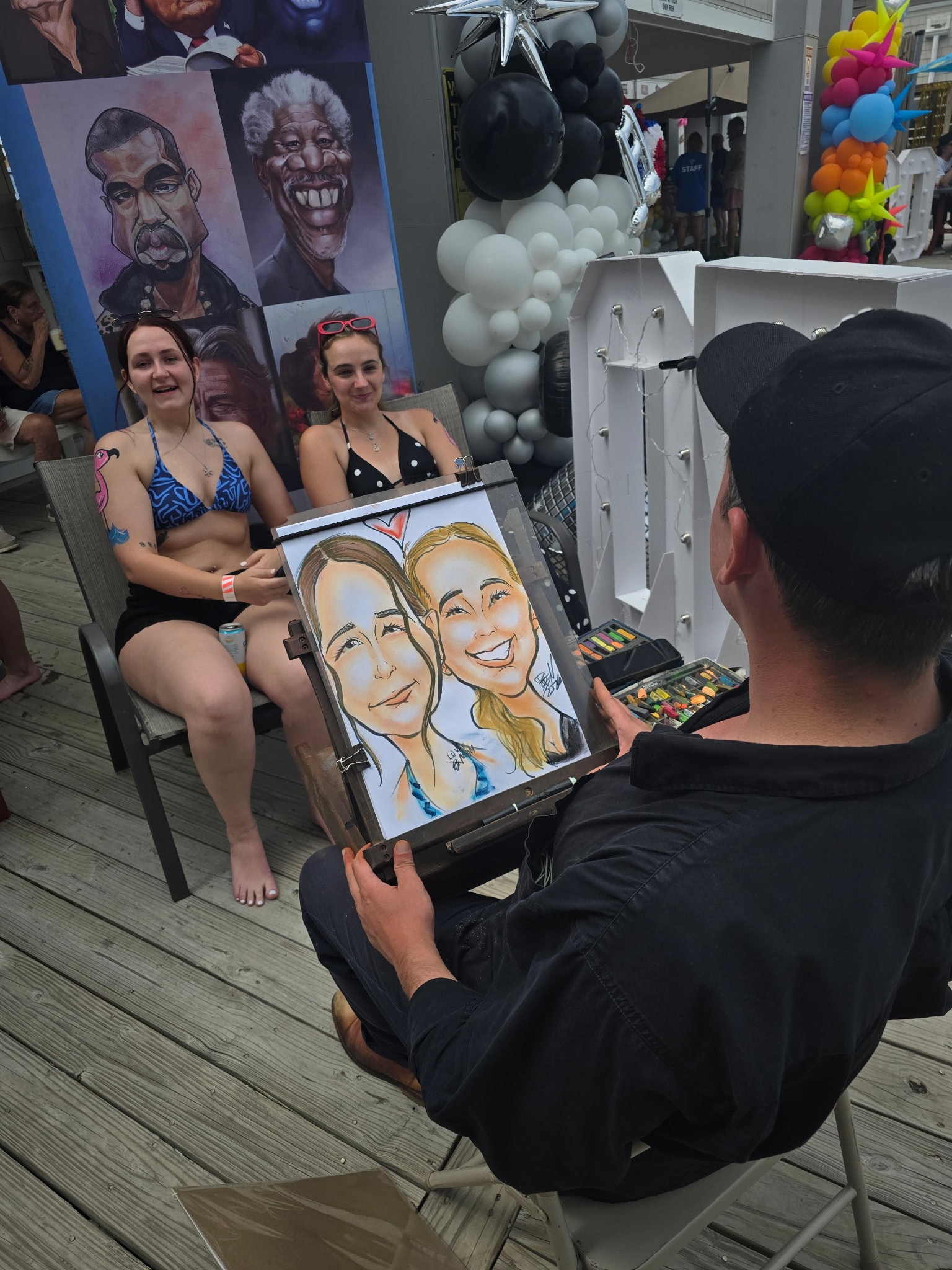Caricature artist drawing guests poolside
